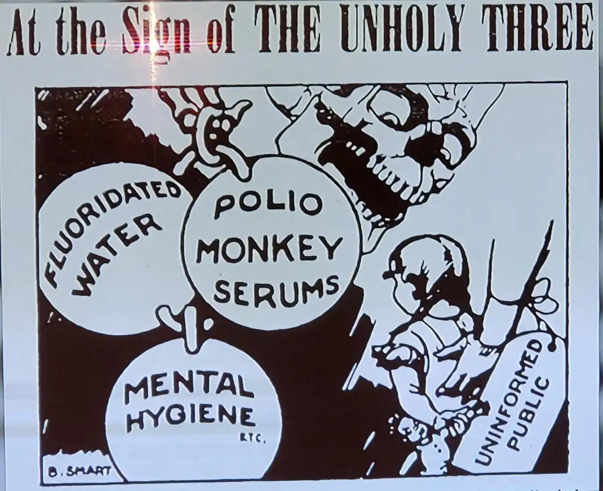 A vintage black-and-white political cartoon titled 'At the Sign of THE UNHOLY THREE' depicts a menacing skull looming over…