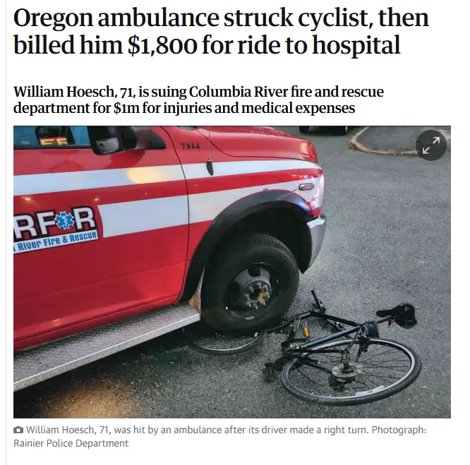 A red Columbia River Fire & Rescue ambulance is shown with its front wheel near a fallen black bicycle on asphalt. The image…