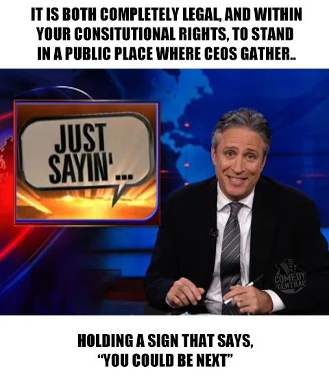A man in a suit sits at a desk with a 'JUST SAYIN'...' speech bubble graphic to his left. The overlaid text reads: 'IT IS…