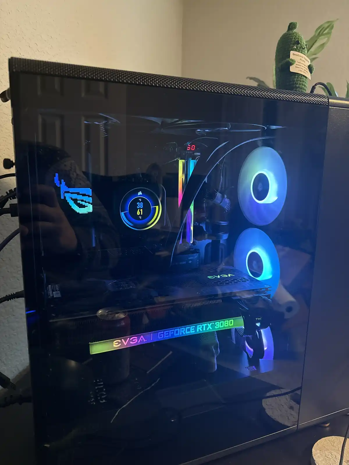 A photo of a custom-built gaming PC with a transparent side panel, showing internal components like an EVGA GeForce RTX 3080…