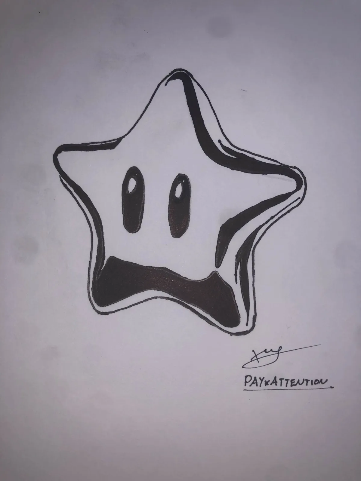 A hand-drawn black-and-white sketch of a five-pointed star with a face, featuring two oval eyes and a wide, downturned mouth…