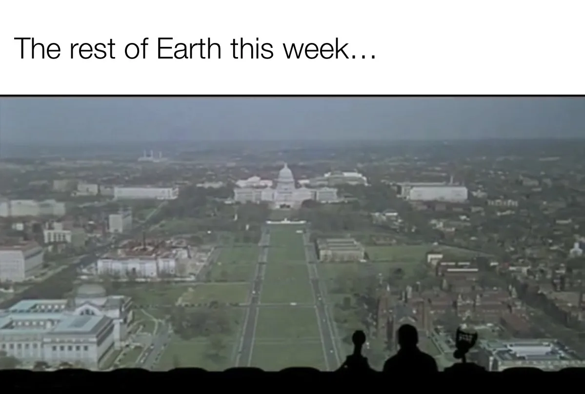 An aerial view of Washington D.C. with the U.S. Capitol building visible in the distance, framed by a wide green lawn and…