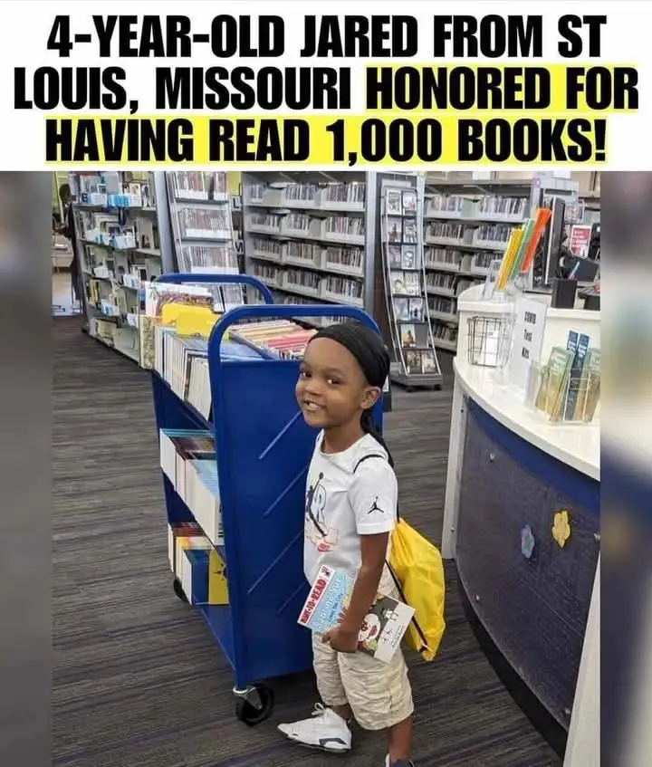 A young Black boy, identified as 4-year-old Jared from St. Louis, Missouri, stands smiling in a library next to a blue book…
