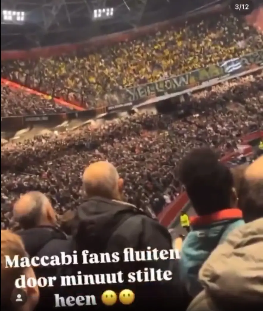 A crowded stadium filled with spectators, many wearing yellow, with a large banner reading 'YELLOW' visible in the stands…