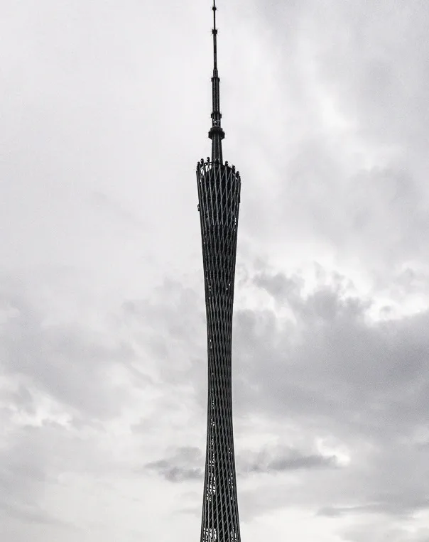 A black-and-white photo shows the top of the Canton Tower against a cloudy sky, with the text 'i'm not a fan of the new…