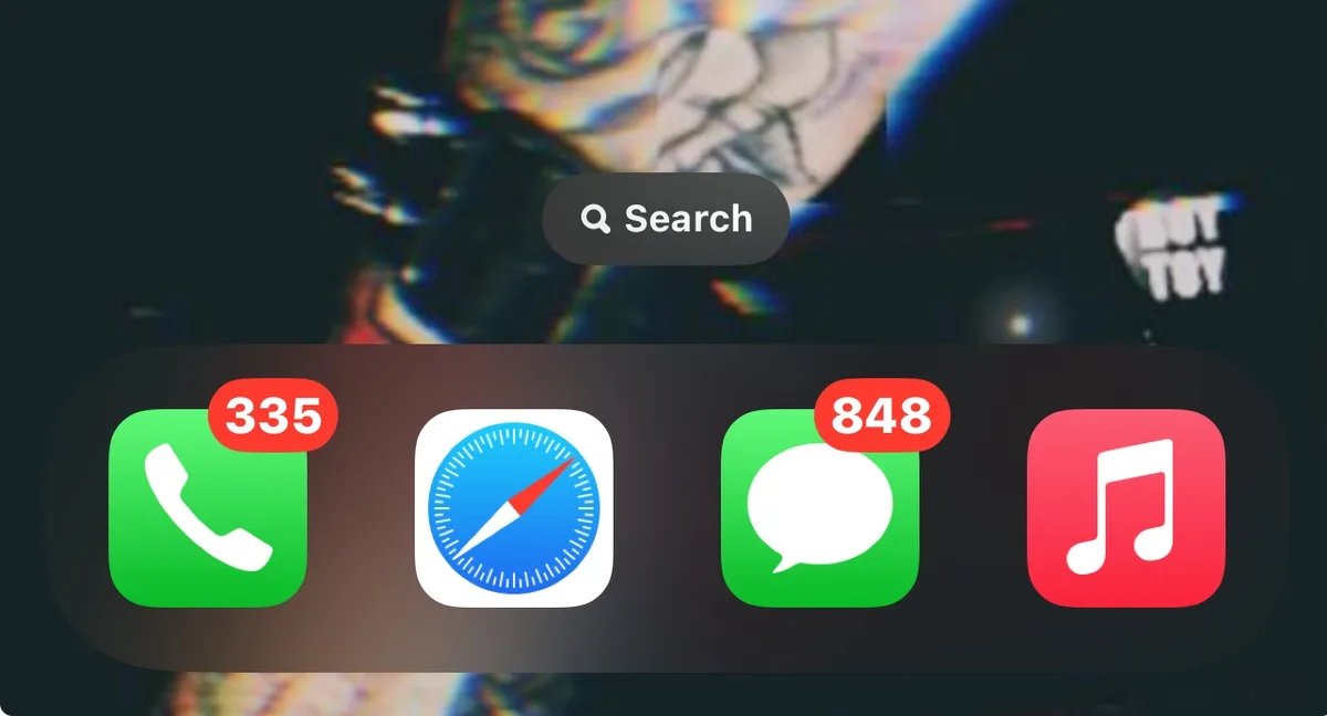 An iPhone home screen with a blurred, colorful background image. Four app icons are visible: Phone (green, with red badge…