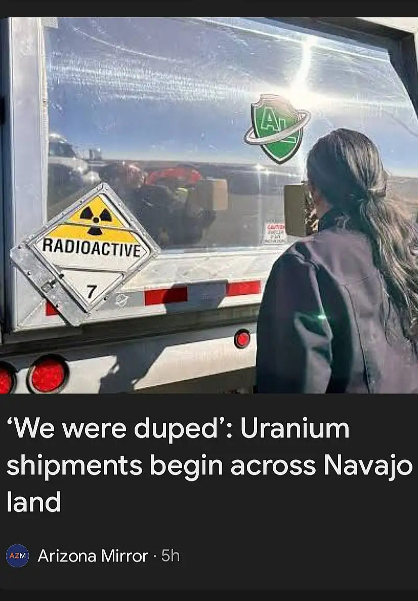 A person in a dark jacket stands outside a truck with a large radioactive warning sign labeled 'RADIOACTIVE 7' on its side…
