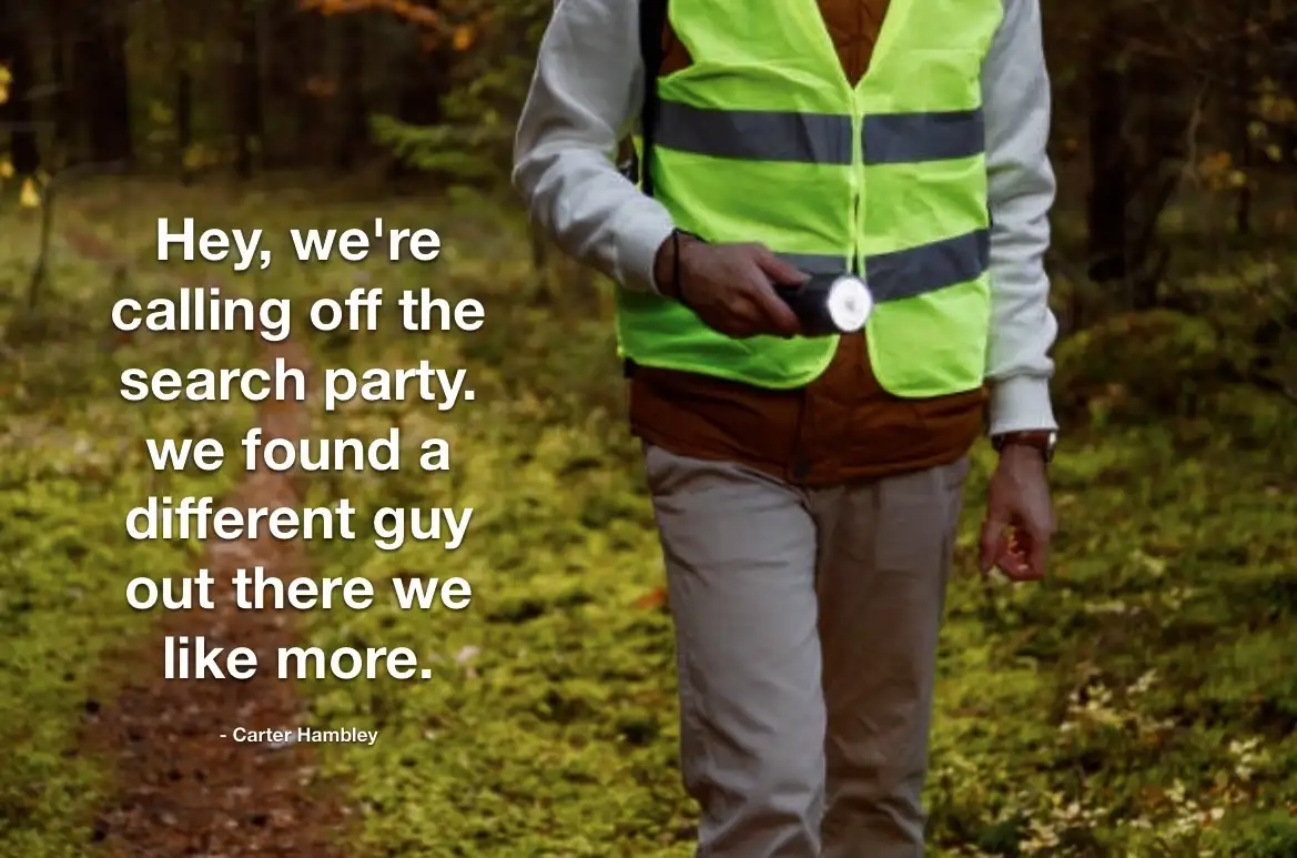 A person in a bright green safety vest and light-colored pants walks through a forest, holding a flashlight. White text…