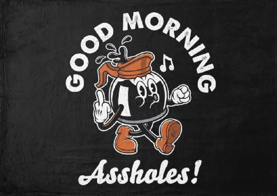 A black towel features a cartoon character resembling a round, black-and-white figure with an orange beret and boots, giving…