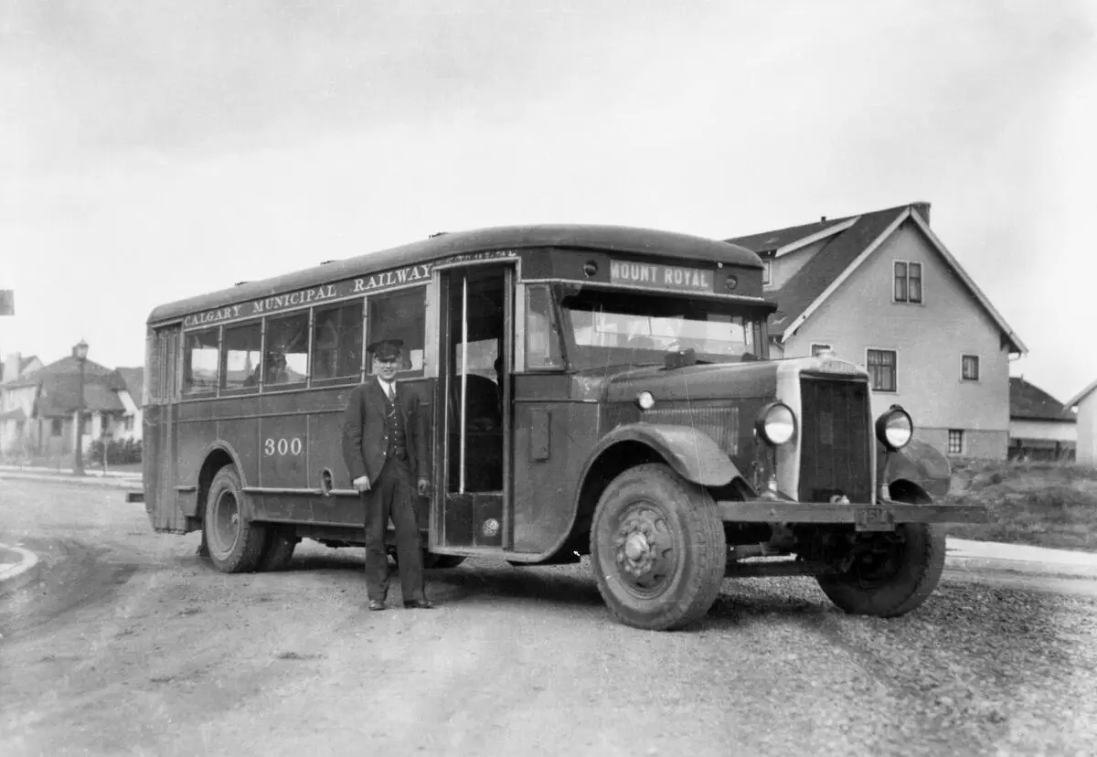 A black-and-white historical photo shows a vintage Calgary Municipal Railway bus, labeled 'MOUNT ROYAL' on its front…