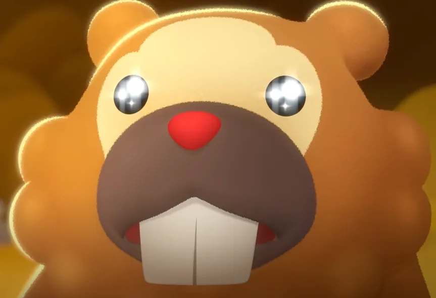 A close-up of a cartoon beaver with large shiny eyes, a red nose, and prominent white buck teeth, looking directly at the…