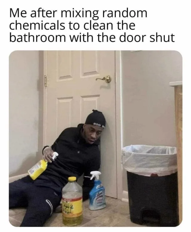 A man in black athletic wear and a black beanie sits slumped on a tiled bathroom floor, looking defeated. He holds a yellow…