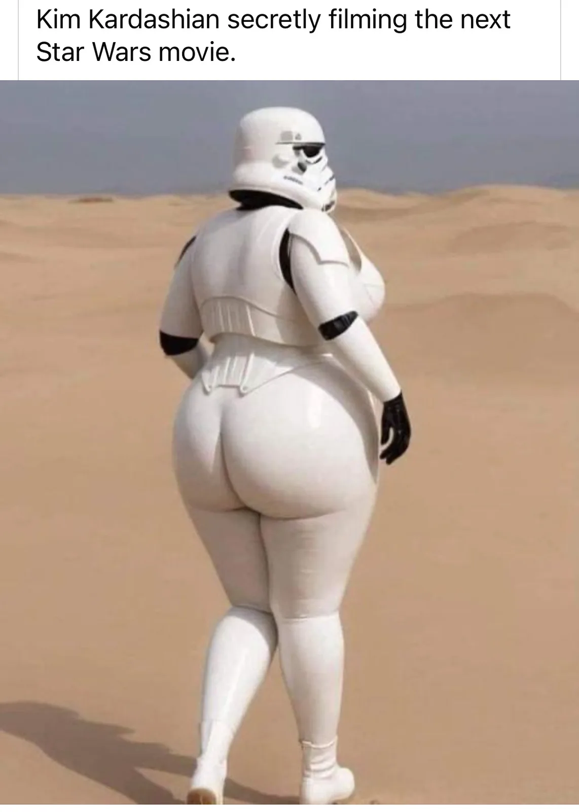 A person in a white, oversized Stormtrooper costume from Star Wars walks away across a desert, showing a very large, rounded…