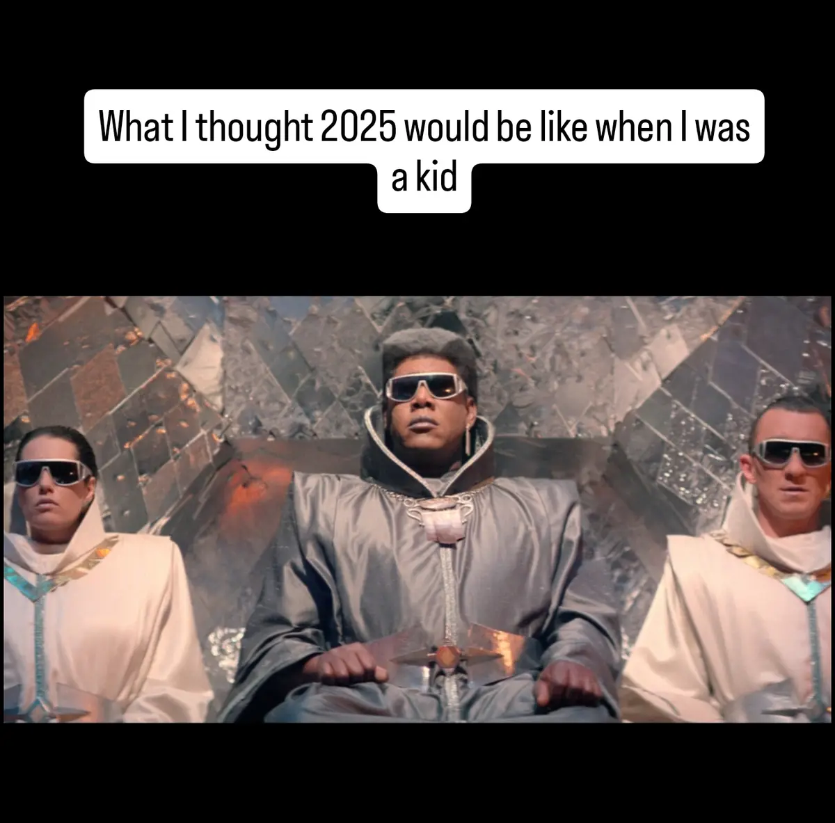 Three people in futuristic, metallic robes and sunglasses sit regally on a throne-like seat against a reflective, fragmented…