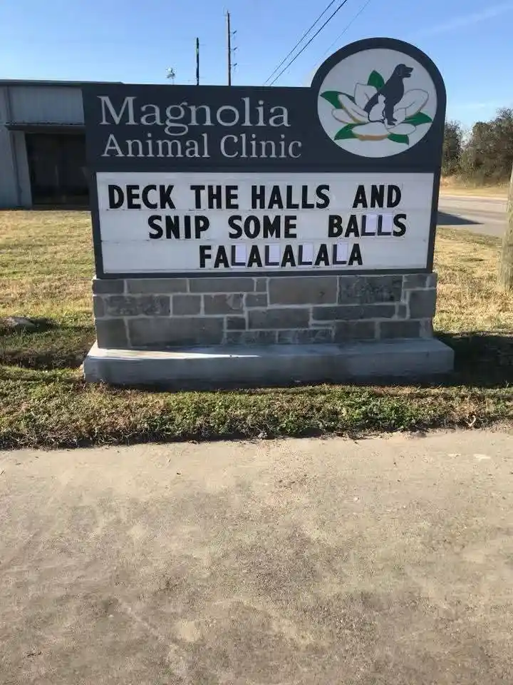 An outdoor sign for 'Magnolia Animal Clinic' features a marquee board with the text 'DECK THE HALLS AND SNIP SOME BALLS…