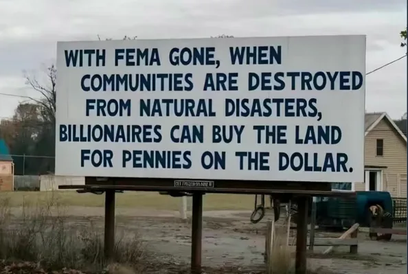 A large white billboard in a rural area displays bold blue text stating that with FEMA gone, when communities are destroyed…