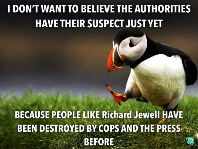 A photograph of a puffin standing on green grass, looking down and to the side with a skeptical expression. White text is…