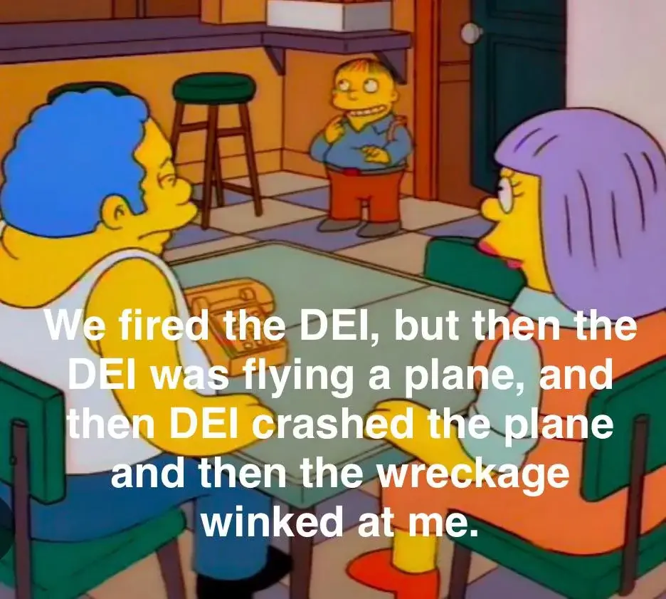 In a scene from The Simpsons, two characters sit at a table facing a third character standing in the background. The…