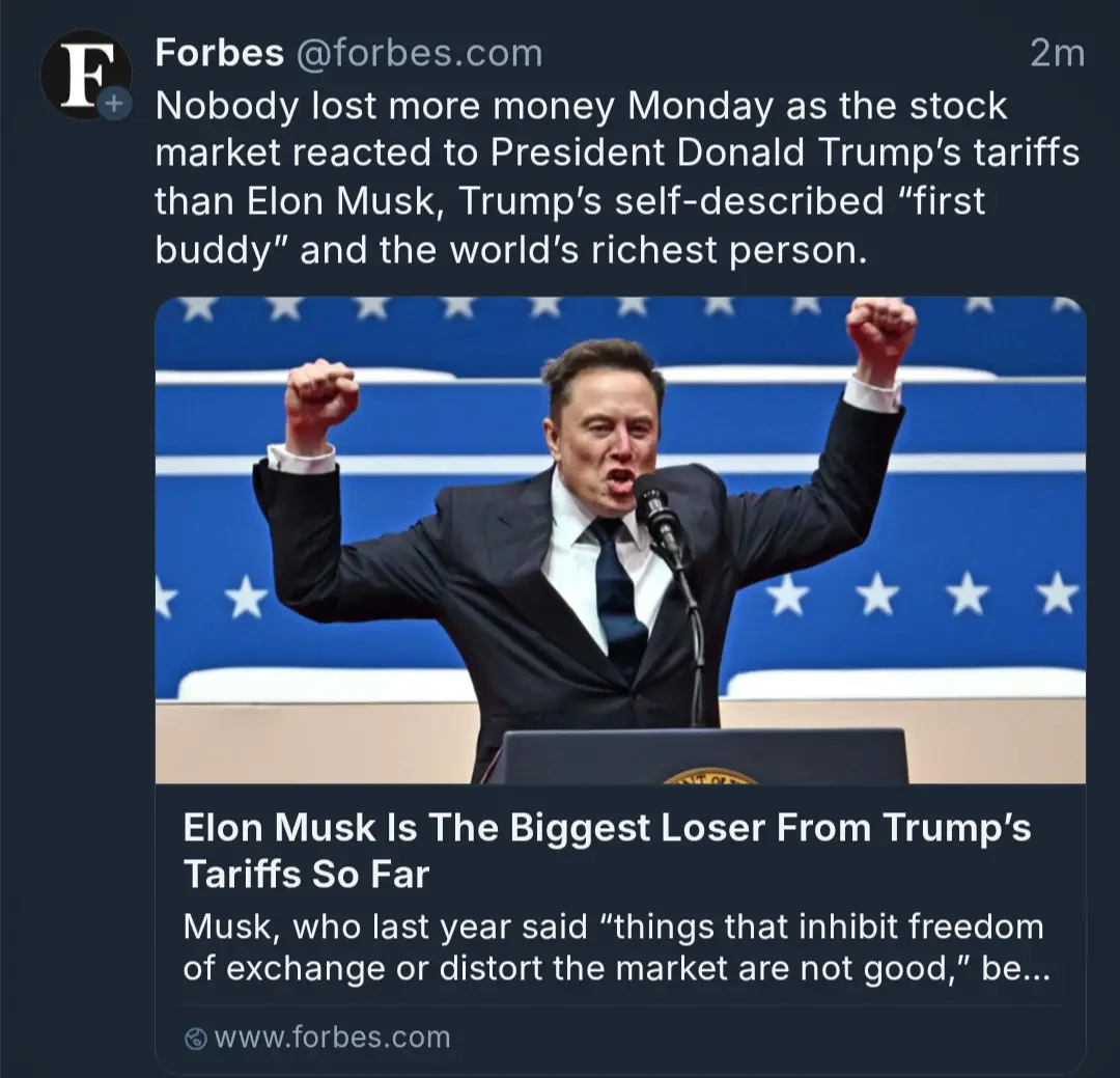 A screenshot of a Forbes tweet shows a photo of Elon Musk in a suit, arms raised in a triumphant pose, standing at a podium…