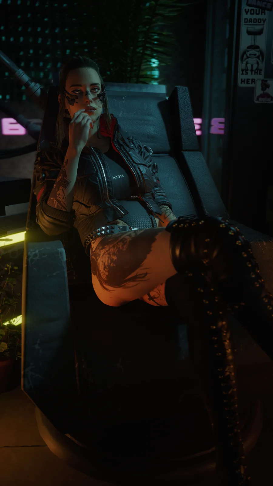A woman with cybernetic facial implants and tattoos reclines in a dark, futuristic chair, wearing a black jacket and studded…