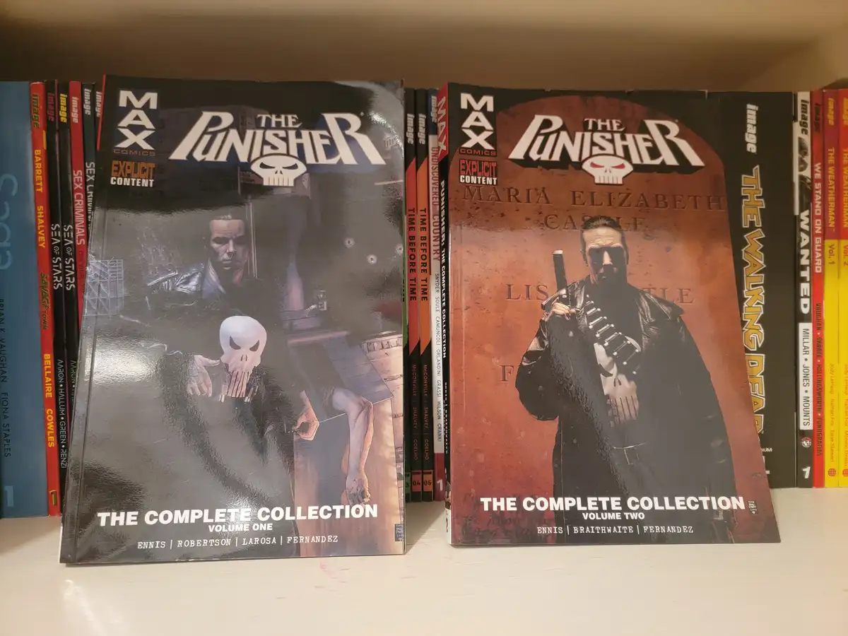 Two large comic book collections for 'The Punisher' are displayed side-by-side on a shelf, labeled 'Volume One' and 'Volume…
