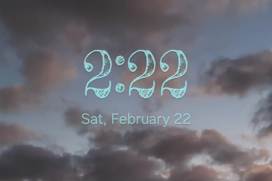 A cloudy sky with soft purples and grays serves as the background for large, stylized turquoise numbers reading '2:22' with…