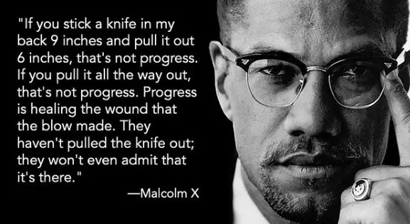 A black-and-white portrait of Malcolm X looking serious, with his hand near his face, wearing glasses and a ring. Overlaid…