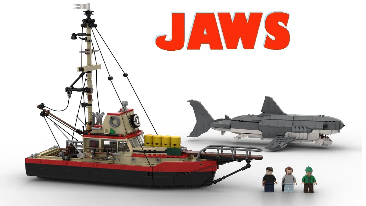 A Lego recreation of the movie 'Jaws' features a detailed Lego fishing boat, a large Lego shark with visible teeth, and…