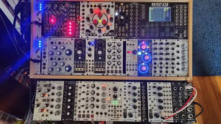 A densely packed modular synthesizer setup with multiple Eurorack modules from brands like Doepfer, Intellijel, and Tiptop…