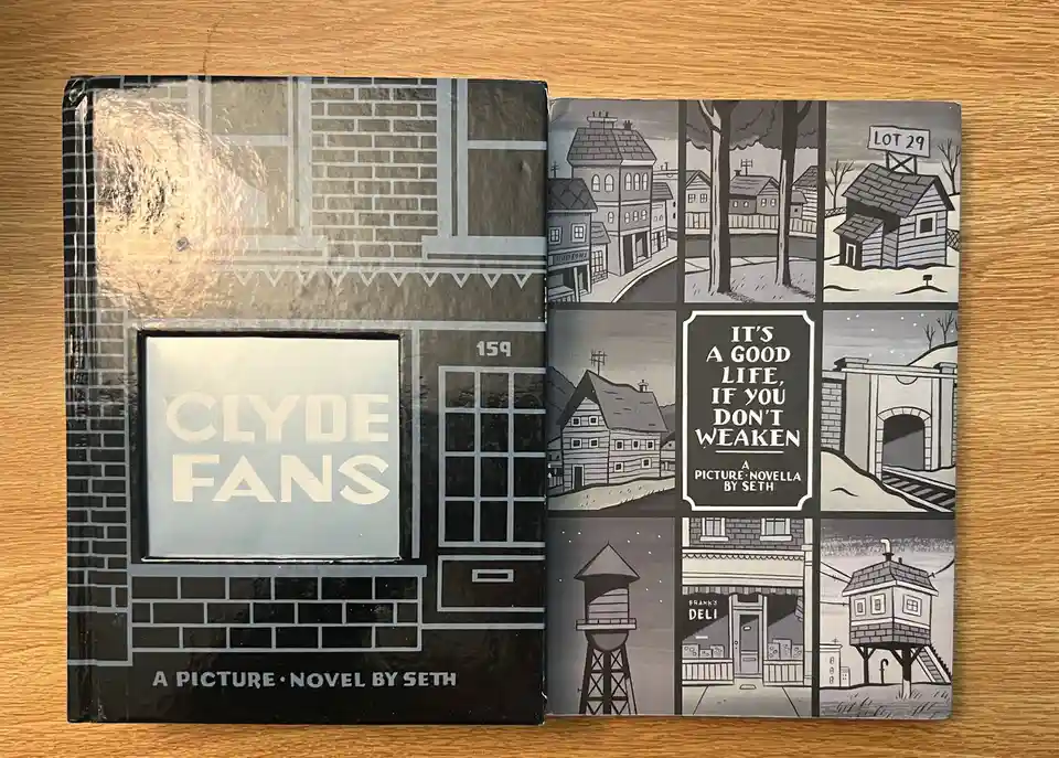 An open book titled 'Clyde Fans' by Seth, showing its cover and inside spread. The cover depicts a brick building with the…