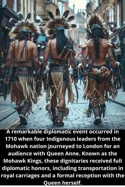 Three Indigenous men in traditional headdresses and regalia walk away from the camera down a cobblestone street in a…