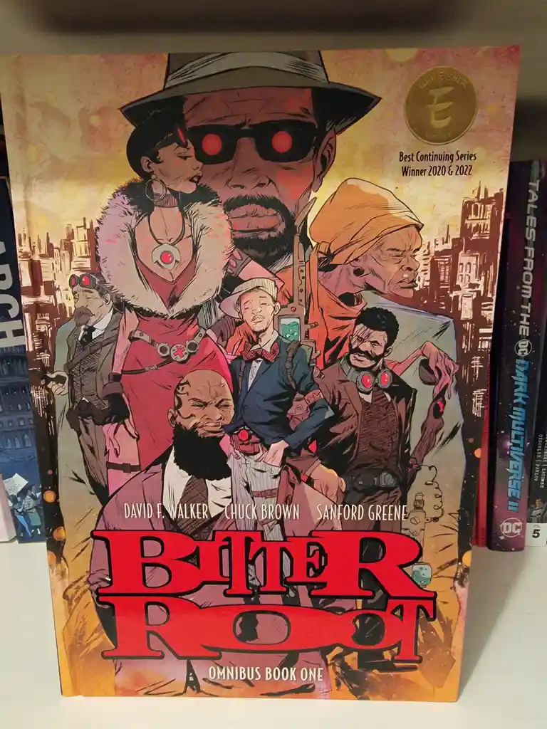 The image shows the cover of the 'Bitter Root Omnibus Book One' comic book, featuring a group of illustrated characters in a…