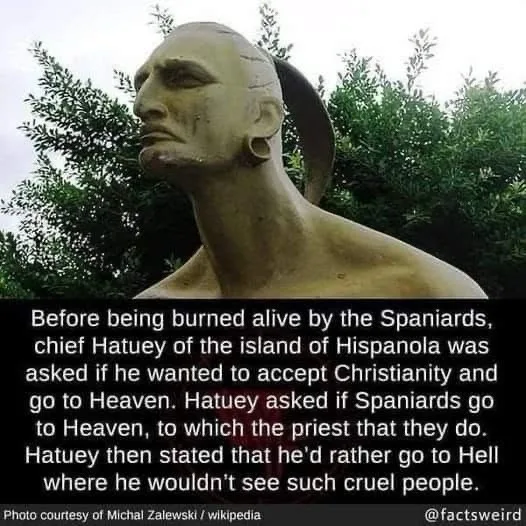 A bronze bust of a man with a shaved head and a ponytail, set against green foliage. A black text box at the bottom contains…