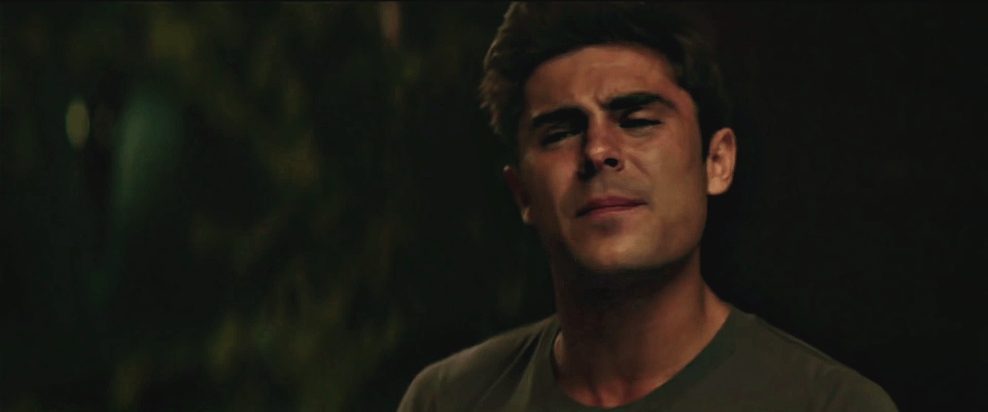 The image shows actor Zac Efron in a sequence of three frames from a movie scene, his facial expression progressively…