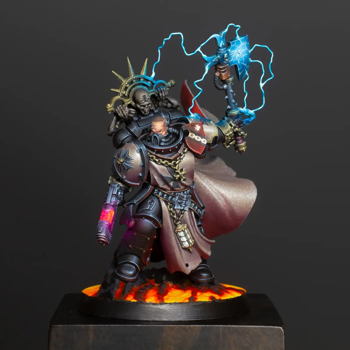 A highly detailed, painted miniature of a grimdark fantasy warrior, likely from Warhammer 40,000, stands on a base with…