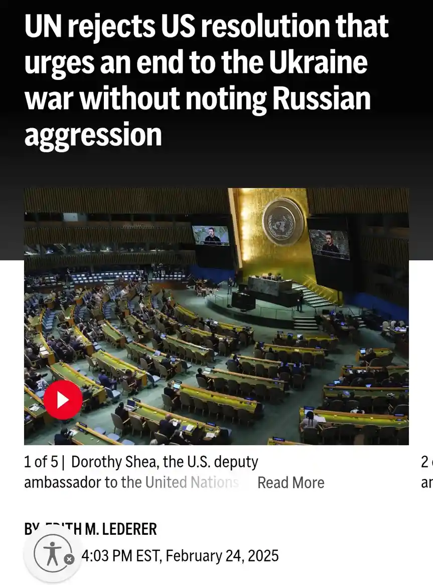 The image shows a wide-angle view of the United Nations General Assembly hall with delegates seated in curved rows facing a…