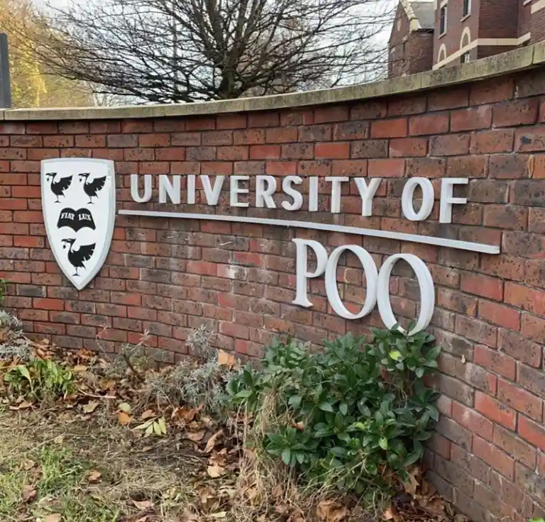 A brick wall sign reads 'UNIVERSITY OF POO' with a shield emblem featuring three black birds and the motto 'FIAT LUX'. The…