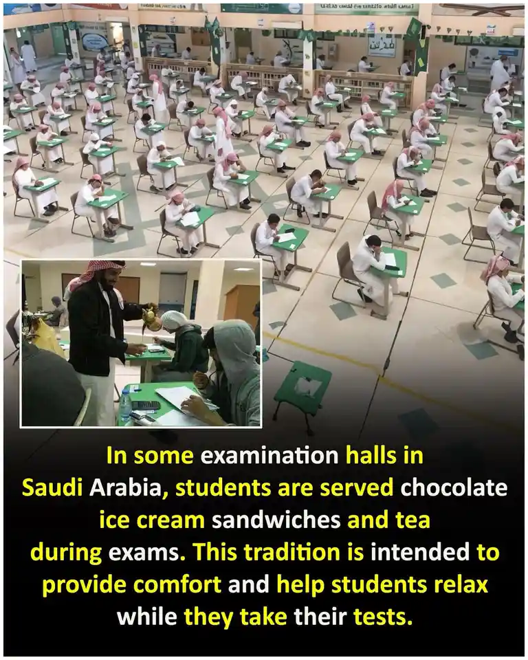 The image shows a large examination hall in Saudi Arabia filled with students in traditional white thobes and head…