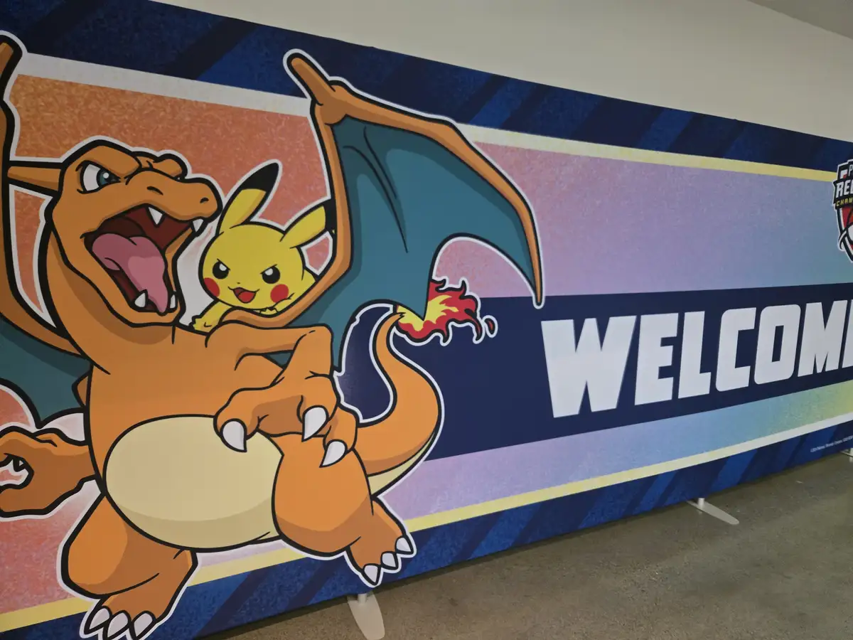 A large banner displays the Pokémon characters Charizard and Pikachu, with Charizard roaring and Pikachu sitting on its…