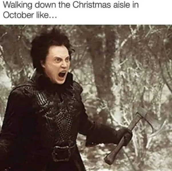 A person with wild hair and an intense expression, wearing dark medieval-style clothing and holding an axe, stands in a…